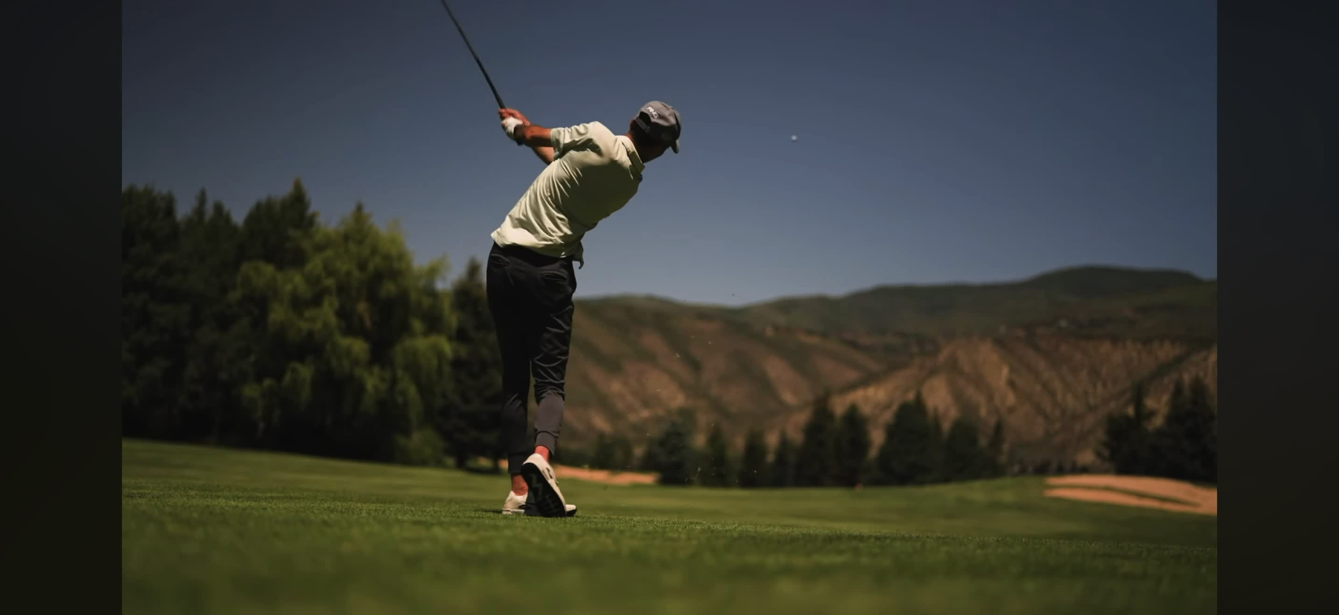 Golfer at the top of his swing on a Colorado fairway